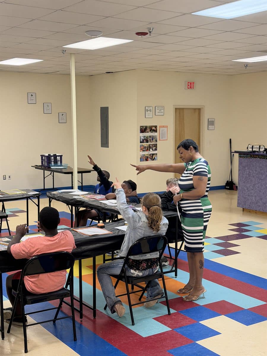 Counselor leading an engaged group session in a school multipurpose room